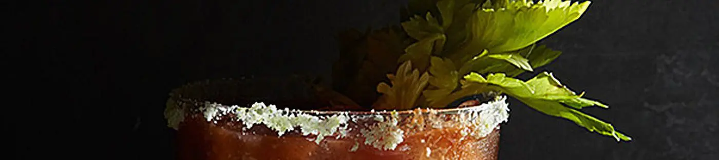 Bloody Mary cocktail with celery garnish.