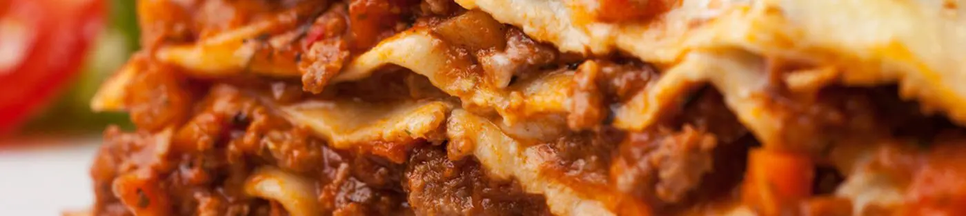 Close-up of a delicious lasagna slice.