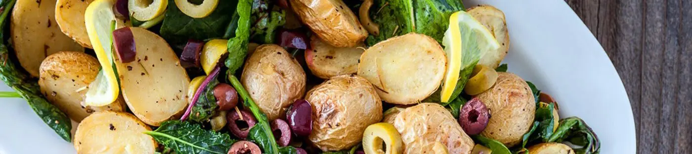 Roasted potatoes with olives and lemon slices.