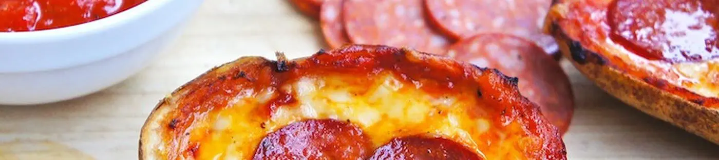 Mini pepperoni pizzas with sauce and slices.