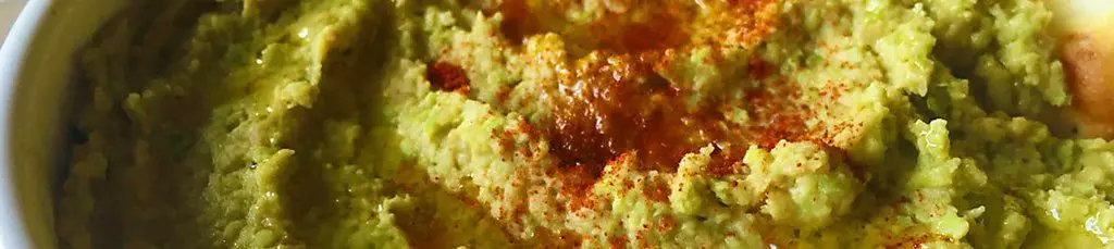 Guacamole topped with paprika in a bowl.